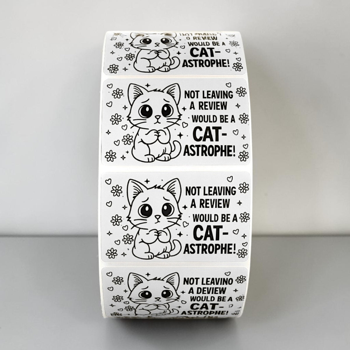 Cat-astrophe review sticker roll held in hand
